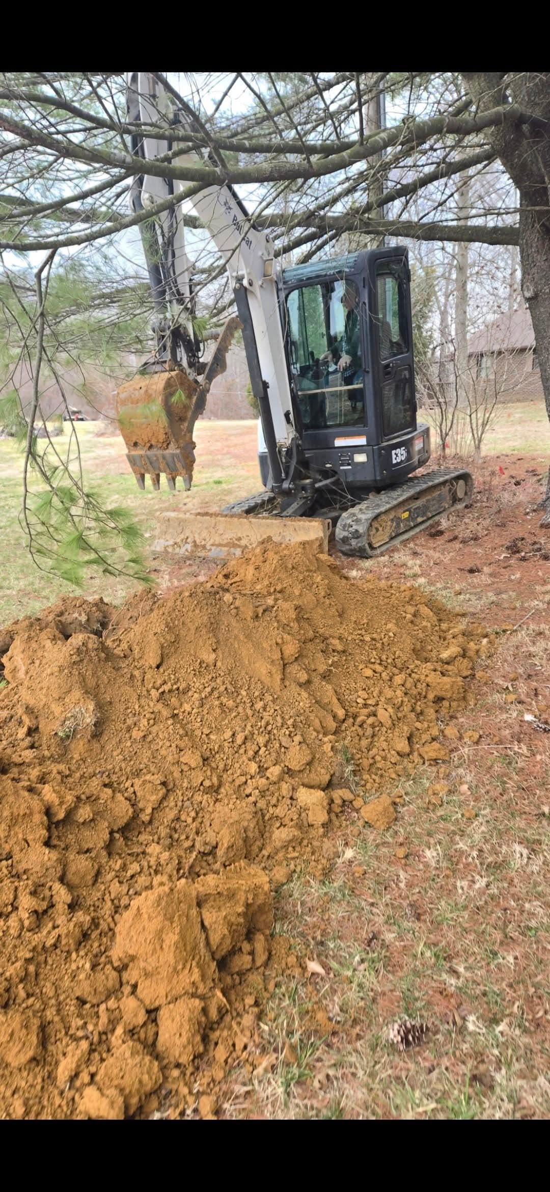 Mini excavator digging on an Owensboro KY property — local excavation contractor